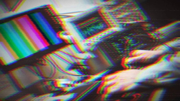 Distorted image of man at a workbench repairing TV