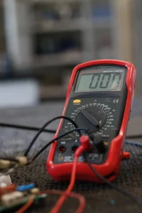 Red Voltmeter sitting on workbench